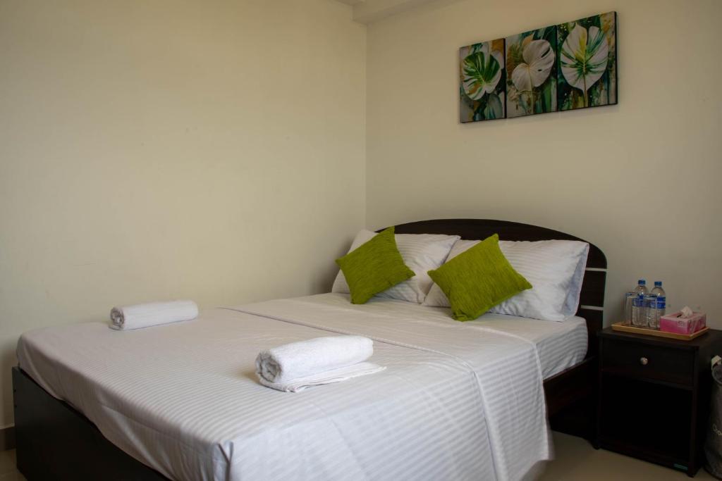 1 dormitorio con 1 cama con toallas en Lovish luxury villa en Colombo