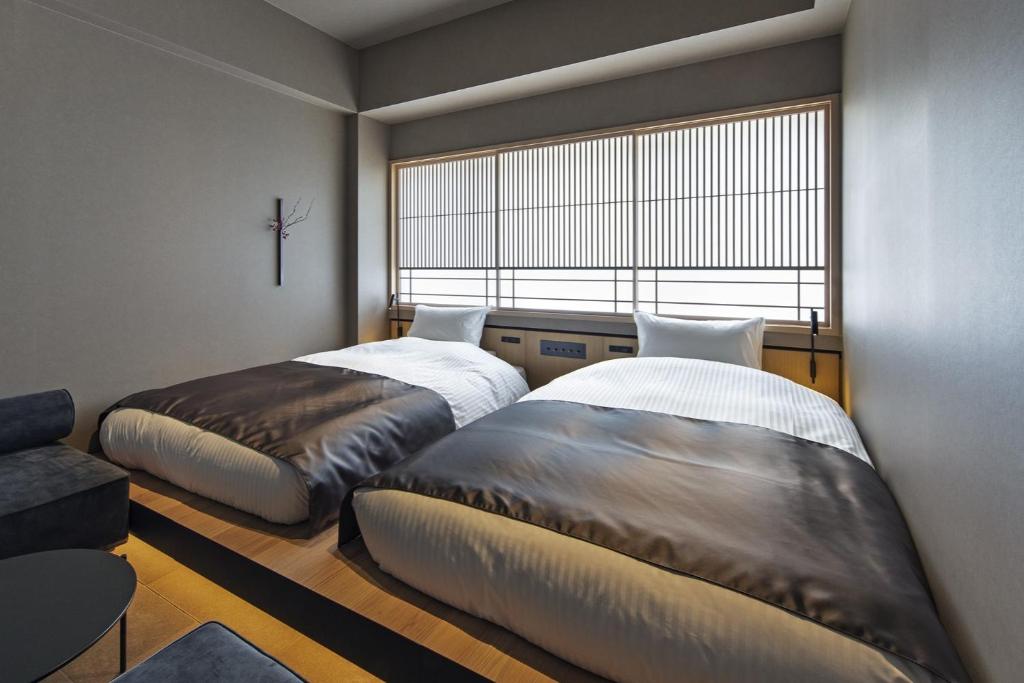 Postel nebo postele na pokoji v ubytování hotel tou nishinotoin kyoto