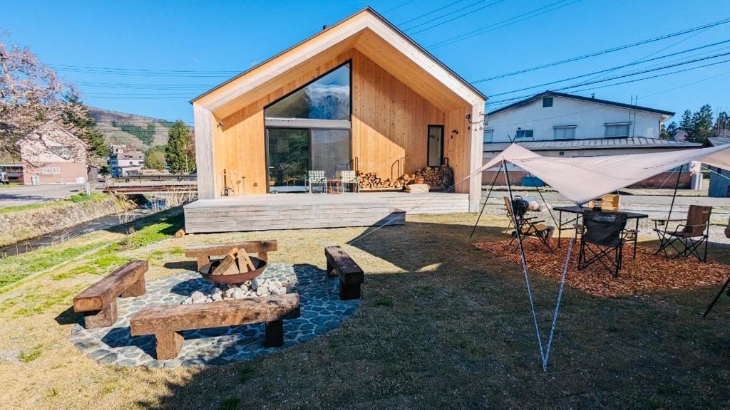 a house with a tent and a fire pit at JOKIJOKI Hakuba in Hakuba