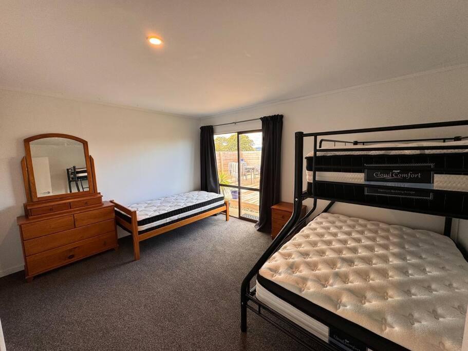 a bedroom with two bunk beds and a mirror at Countryside peace and comfort , in Cambridge