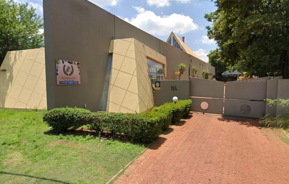 a building with a bush in front of it at See You There Accommodation in Centurion