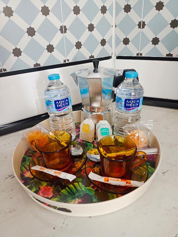 a tray filled with bottles of water and food at La viña de camarata in Aguilar de la Frontera