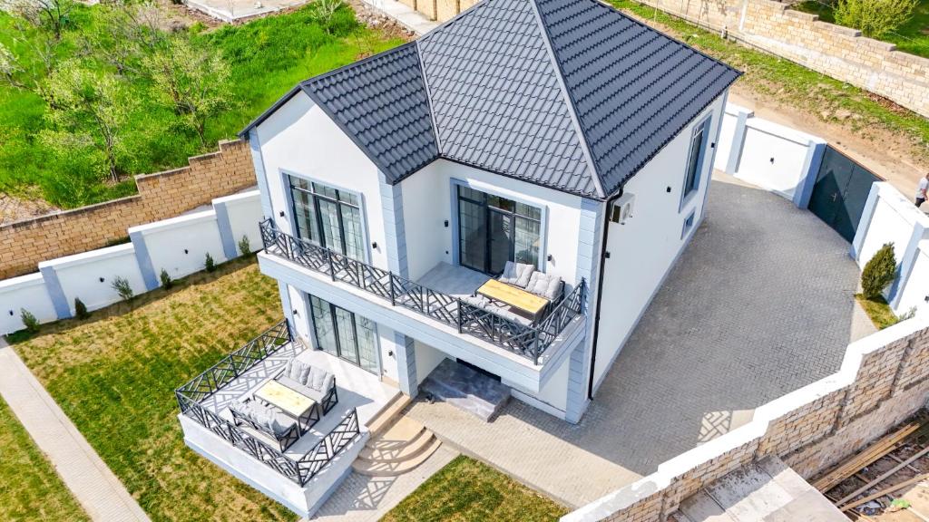 an overhead view of a white house with a black roof at White Harmony House in Şamaxı