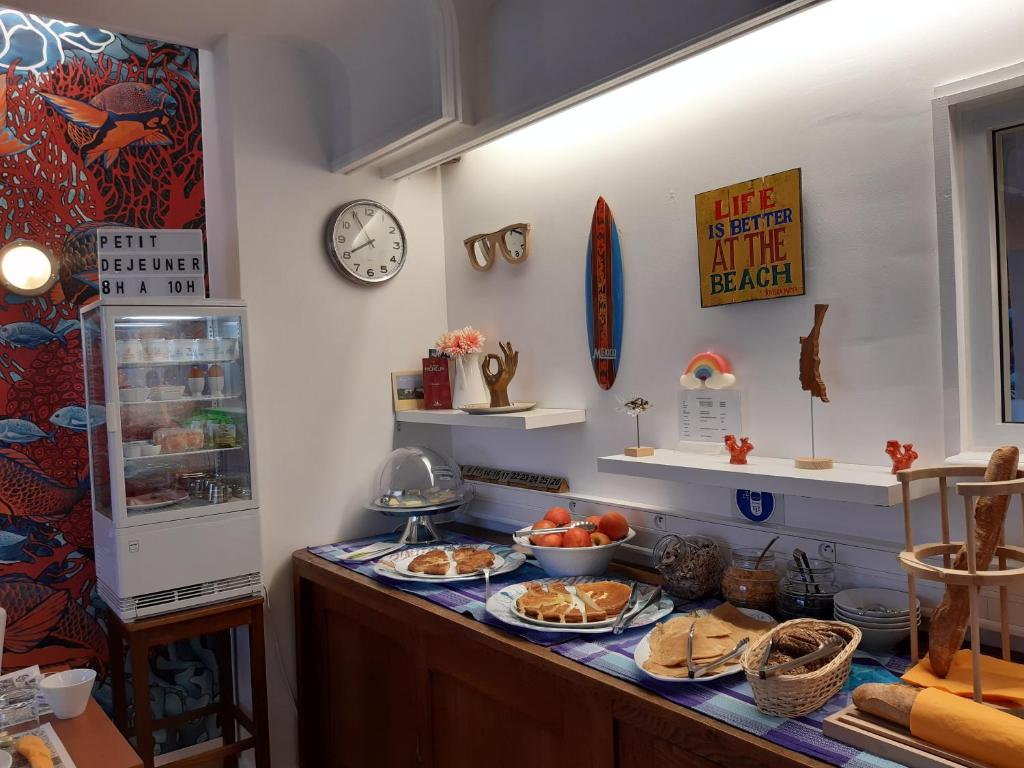 a kitchen with a counter with plates of food on it at Hôtel Ker-Noyal Quiberon Plage in Quiberon