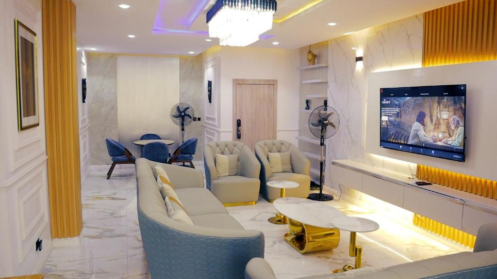 a waiting room with couches and a tv in a lobby at Seaview Apartment, Ikoyi in Lagos