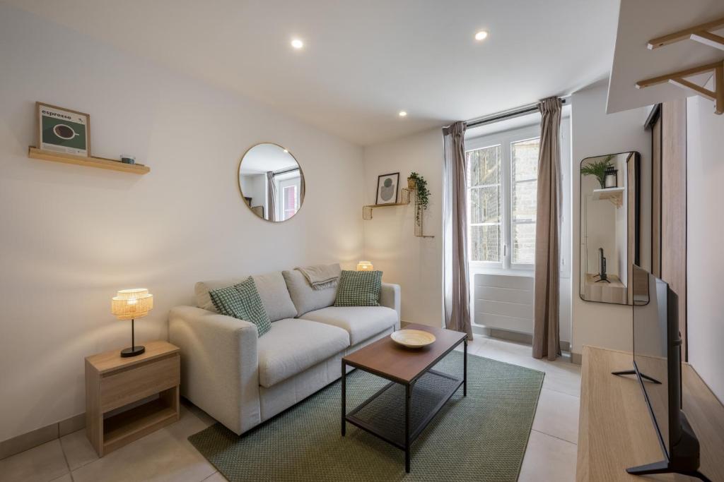 a living room with a couch and a table at Le petit bijou de Tournon : confort et moderne in Tournon-sur-Rhône