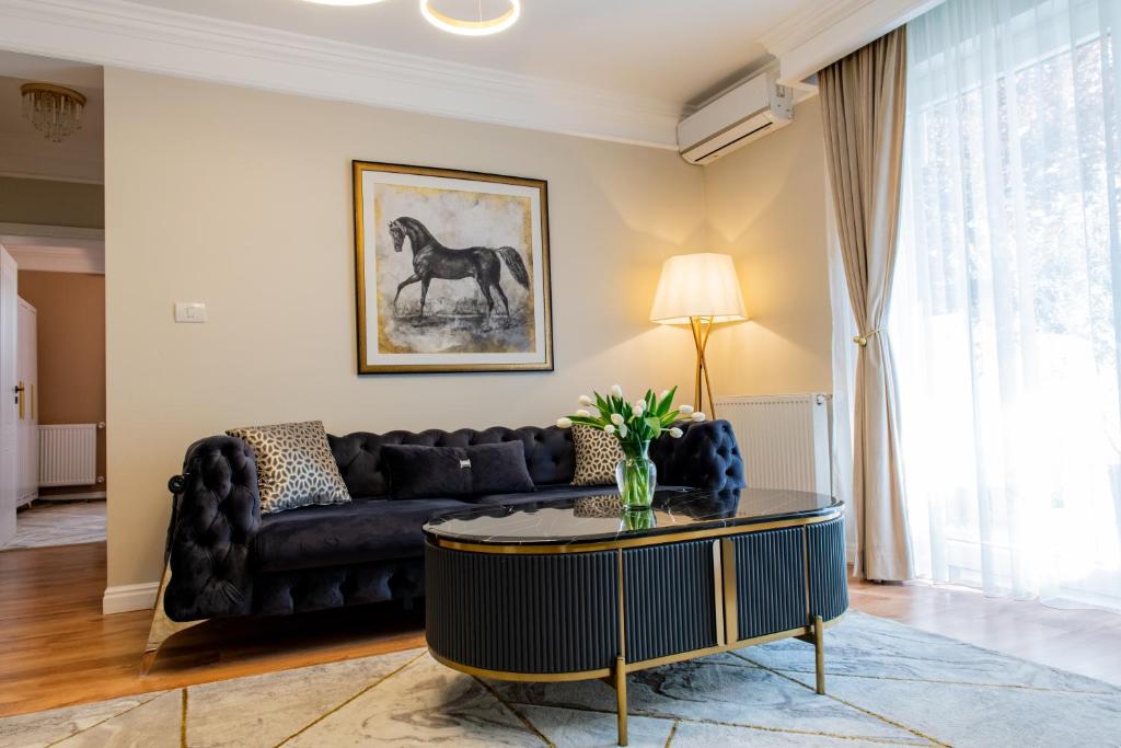 a living room with a couch and a table at Olive Apartment in Timişoara