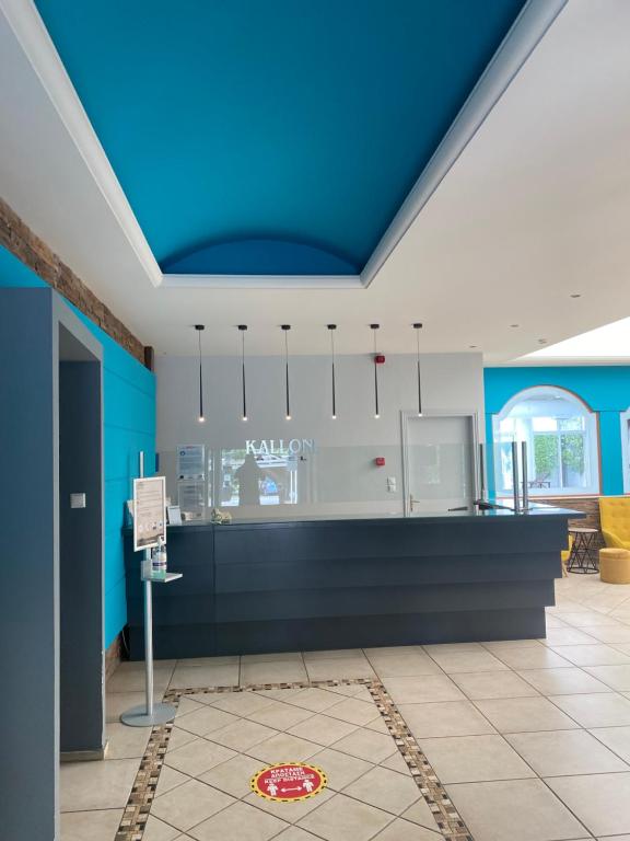 a room with a blue ceiling and a counter at Hotel Kalloni in Volos