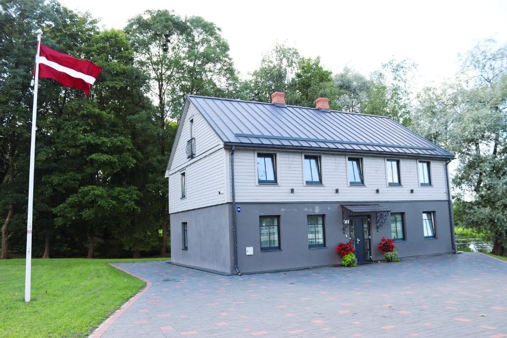 a house with a flag on the side of it at Saules iela 2A in Saldus