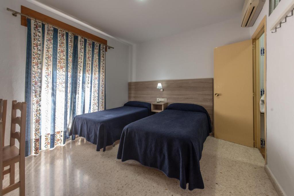 Posteľ alebo postele v izbe v ubytovaní Hotel San Andres