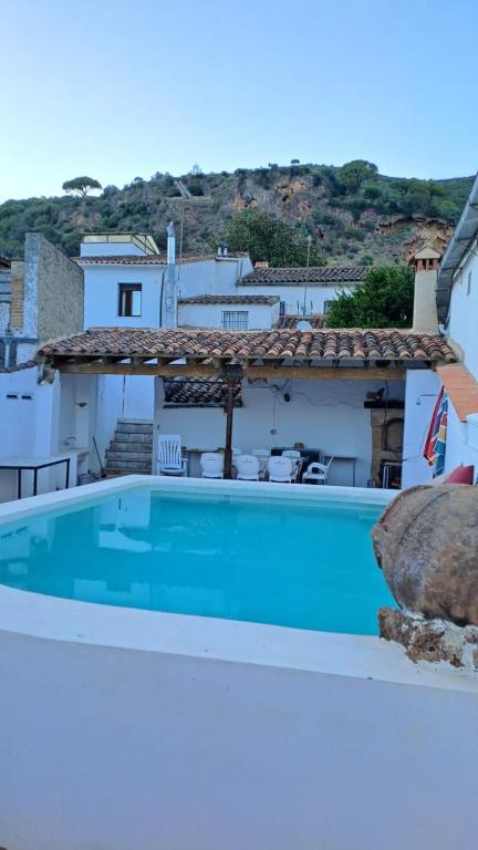 a large swimming pool in front of a house at Casa Moya Villa Lujo in Alájar