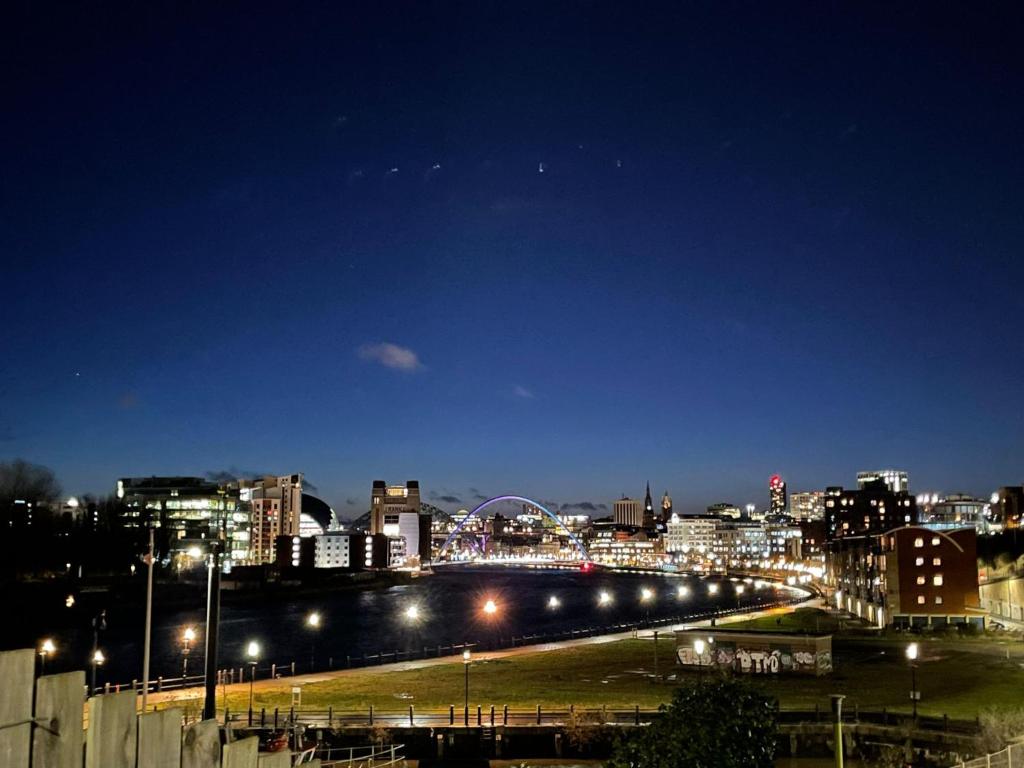 uma cidade iluminada à noite com luzes de rua em PartyPad Newcastle em Saint Peters