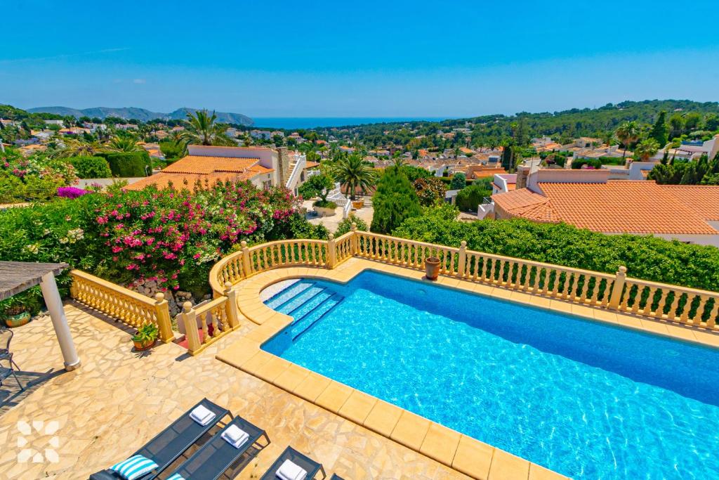 a swimming pool with a balcony with a view at Villa Perla by Abahana Villas in Teulada
