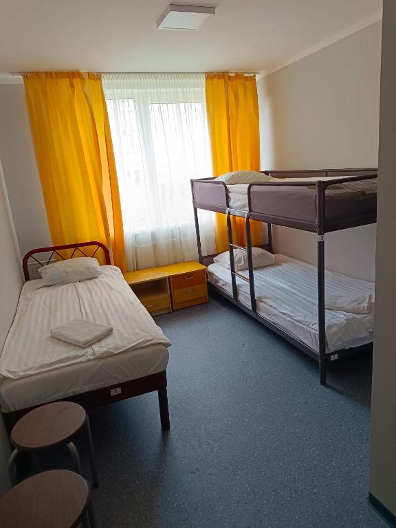 a room with two bunk beds and a window at Sofijas Rooms in Rīga