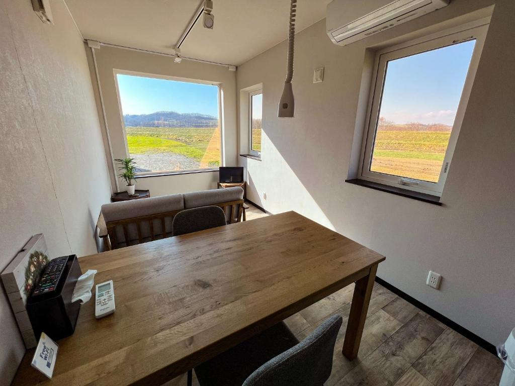a room with a table and chairs and two windows at FLEXWORK tawa - Vacation STAY 75820v in Teshikaga
