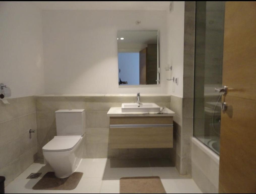 a bathroom with a toilet and a sink and a shower at Cairo in El Alamein