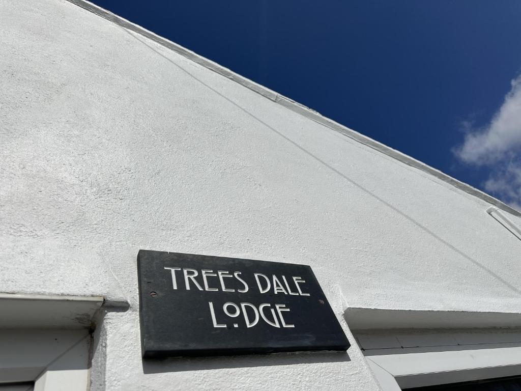 a sign on the side of a white building at Immaculate 2-Bed Lodge in Hayle in Hayle