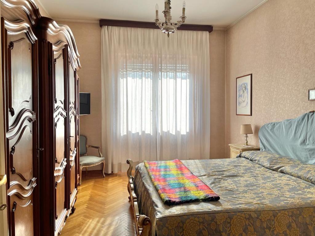a bedroom with a bed and a window at Casa di Charme lungo Po in Turin