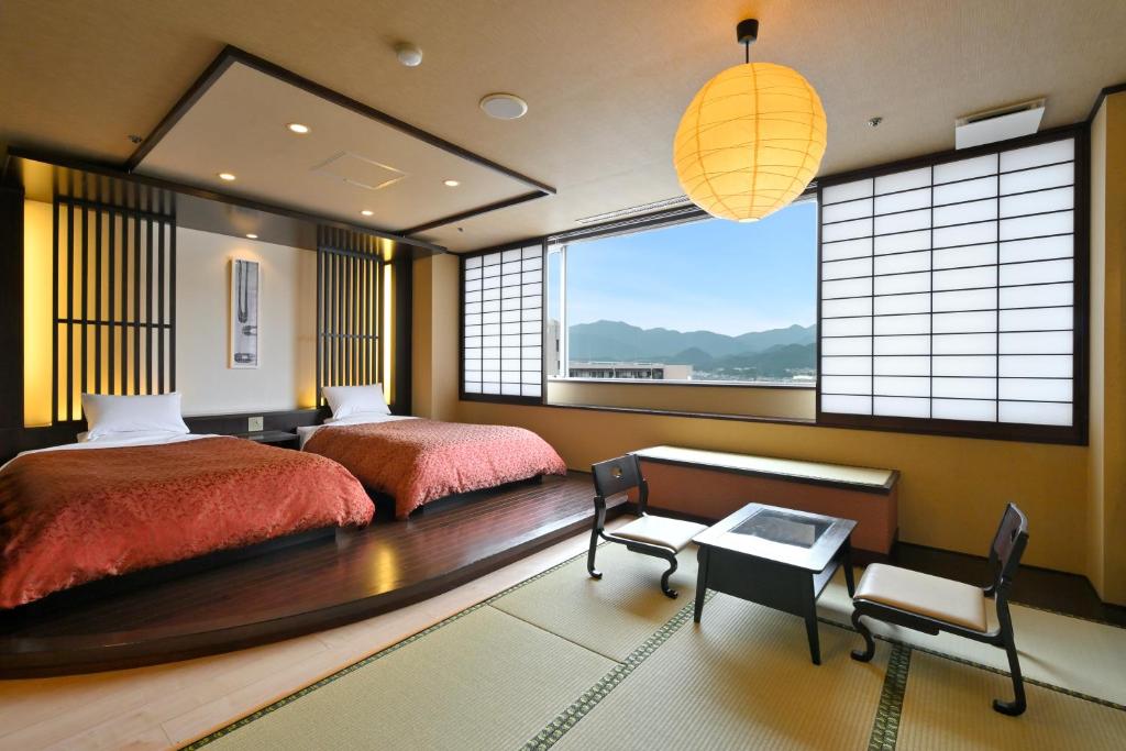 Postel nebo postele na pokoji v ubytování U-BELL Hotel Matsumasa
