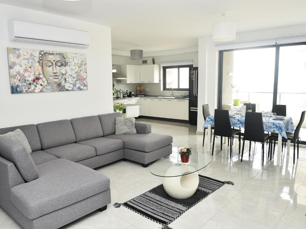a living room with a couch and a dining room at Seaview-CasadiAlfio-Qawra in St Paul's Bay