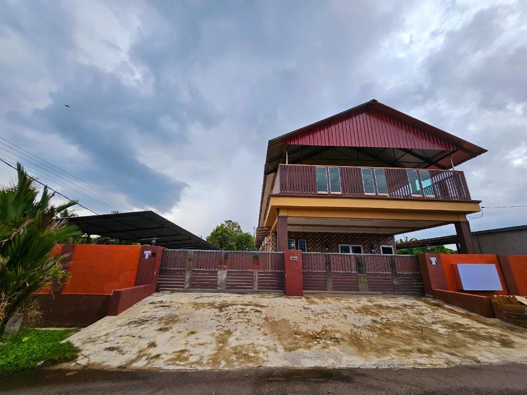 a house with a red roof and a fence at The Blue Guest House, Parking, Aulong in Taiping