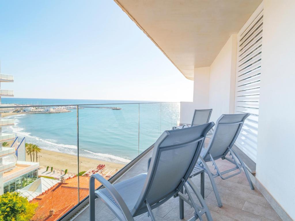 a balcony with chairs and a view of the beach at Spirit Hotel Benalmadena Beach in Benalmádena