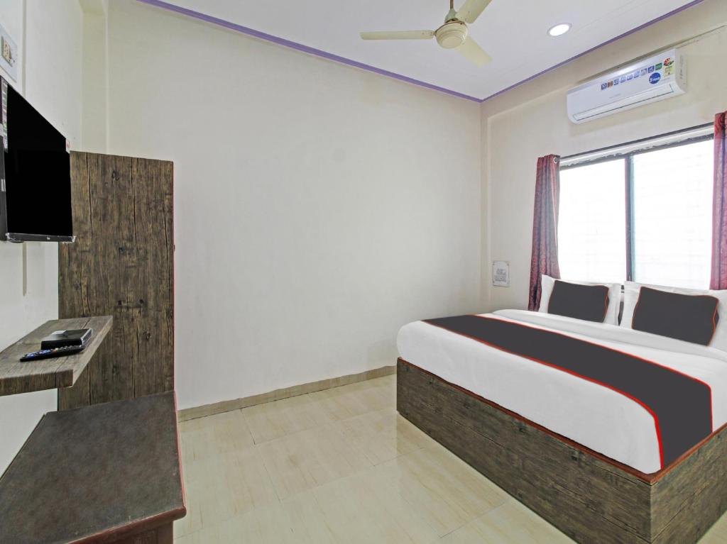 a hotel room with a bed and a television at Super Collection O Fortune Inn in Pune