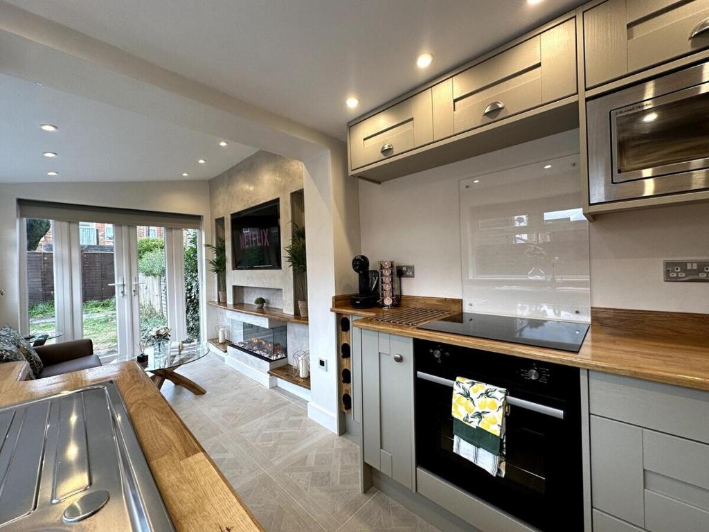 a kitchen with a sink and a stove top oven at Deluxe Stays @ Libra Spaces in Hull