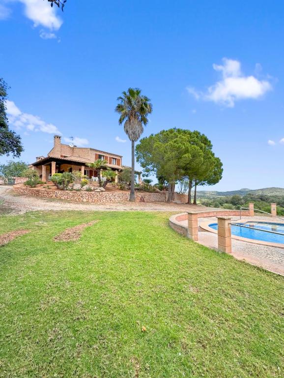 a house with a swimming pool and a house at Finca Son Manxo (villas2meet Mallorca) in Manacor