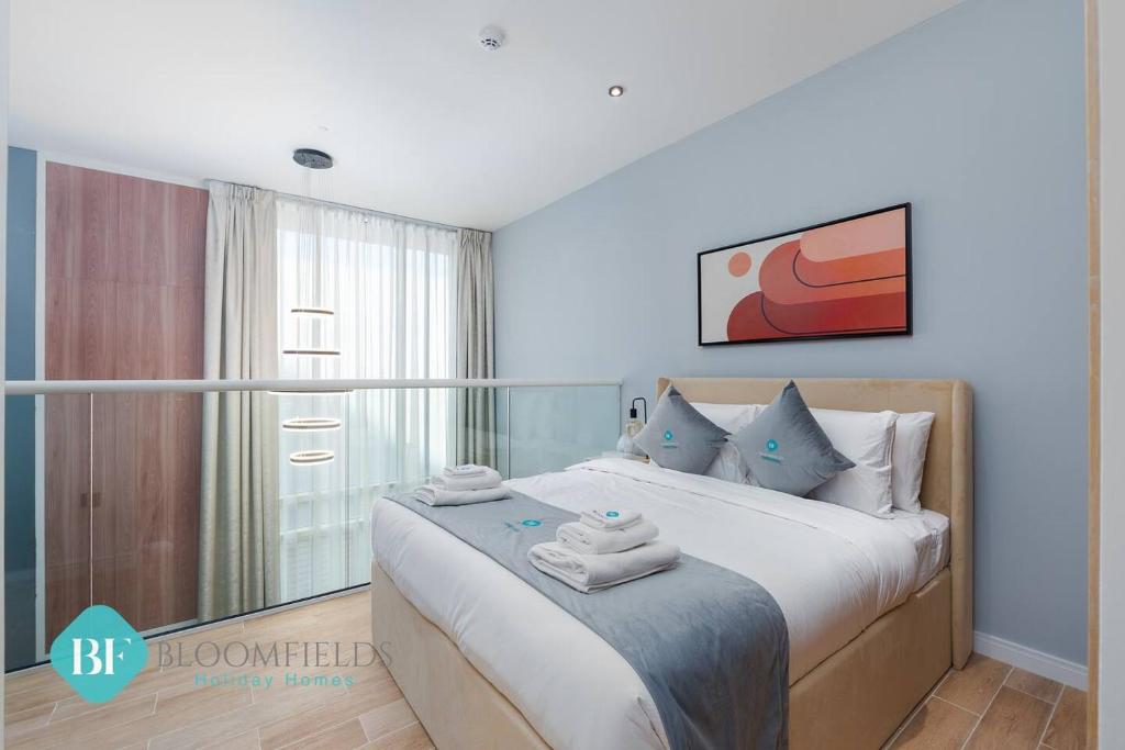 a bedroom with a bed with towels on it at Premium 1 Br Duplex In Rukan in Dubai