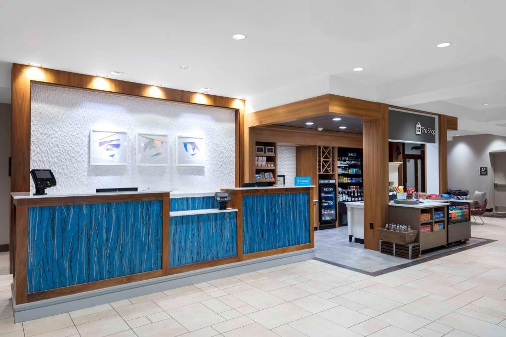 a lobby of a store with a blue counter at Hilton Garden Inn Charleston / Mt. Pleasant in Charleston