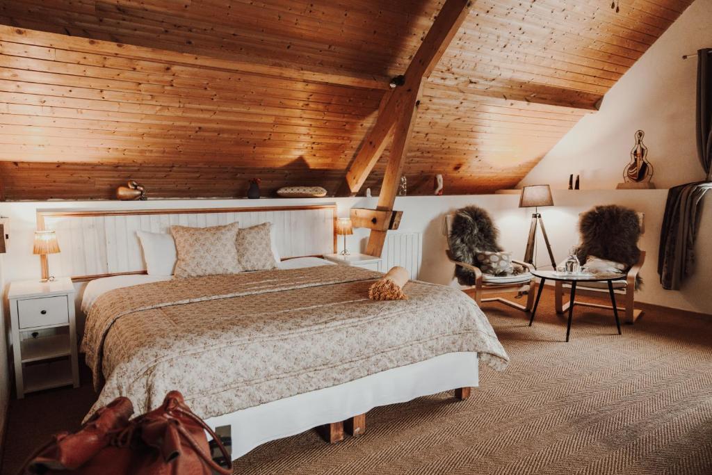ein Schlafzimmer mit einem Bett und einer Holzdecke in der Unterkunft Les Perséides in Lézignan