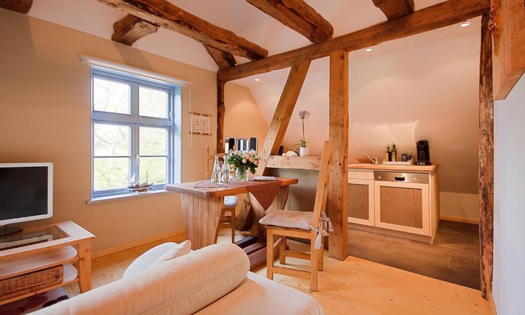a living room with a couch and a table and a tv at Haus zu den Büschen 04 in Wustrow