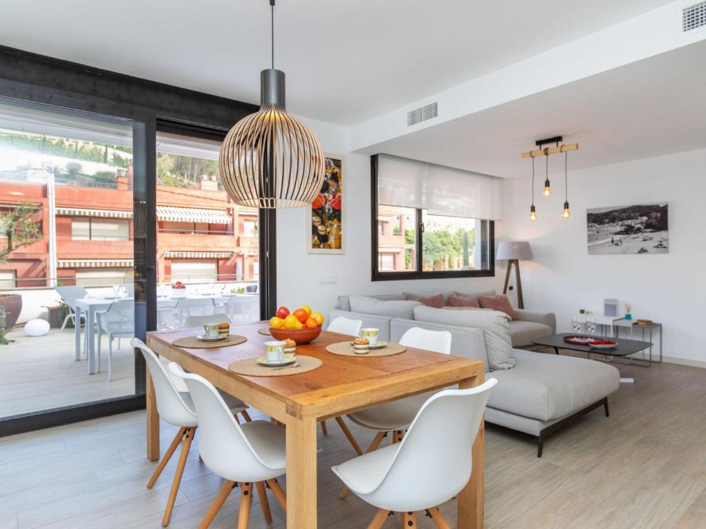 a dining room and living room with a table and chairs at Holiday Home Sa Riera White on the Beach by Interhome in Begur