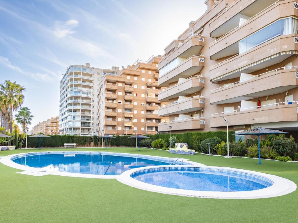 een zwembad voor een gebouw bij Apartment Vistamar II - Marina d'Or by Interhome in Oropesa del Mar