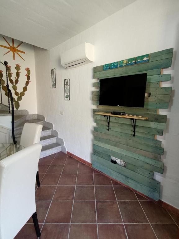 a living room with a flat screen tv on a wall at Villa Olga in Nebida
