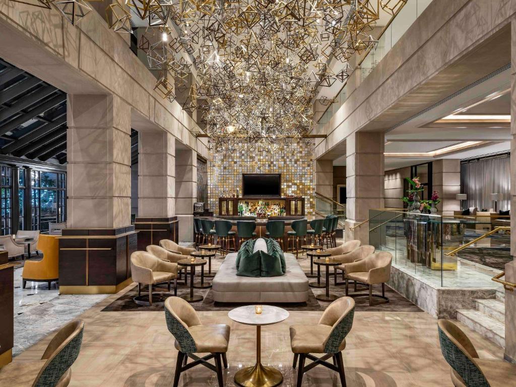 a lobby with chairs and tables in a building at The Fairmont Washington DC in Washington