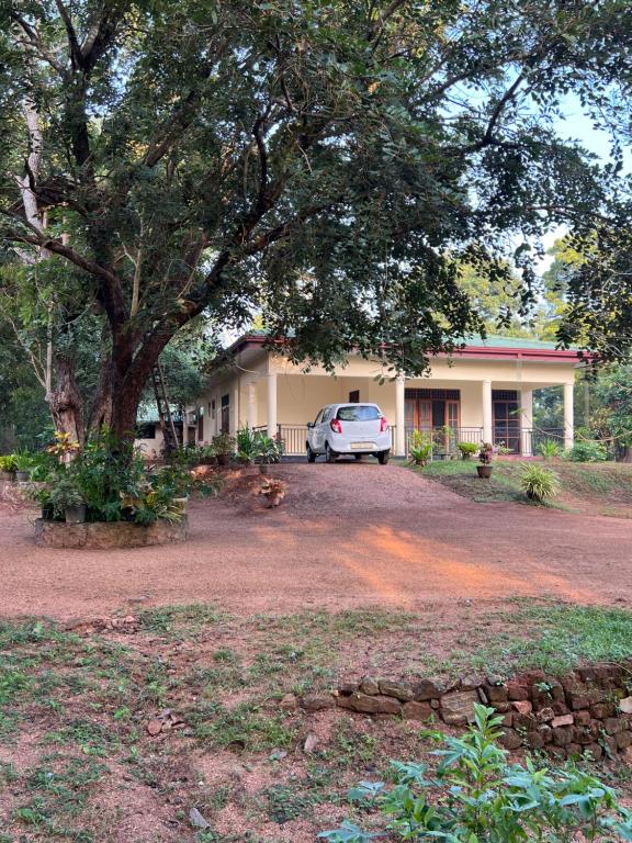 un coche aparcado frente a una casa en Green Haven Holiday Home en Anuradhapura