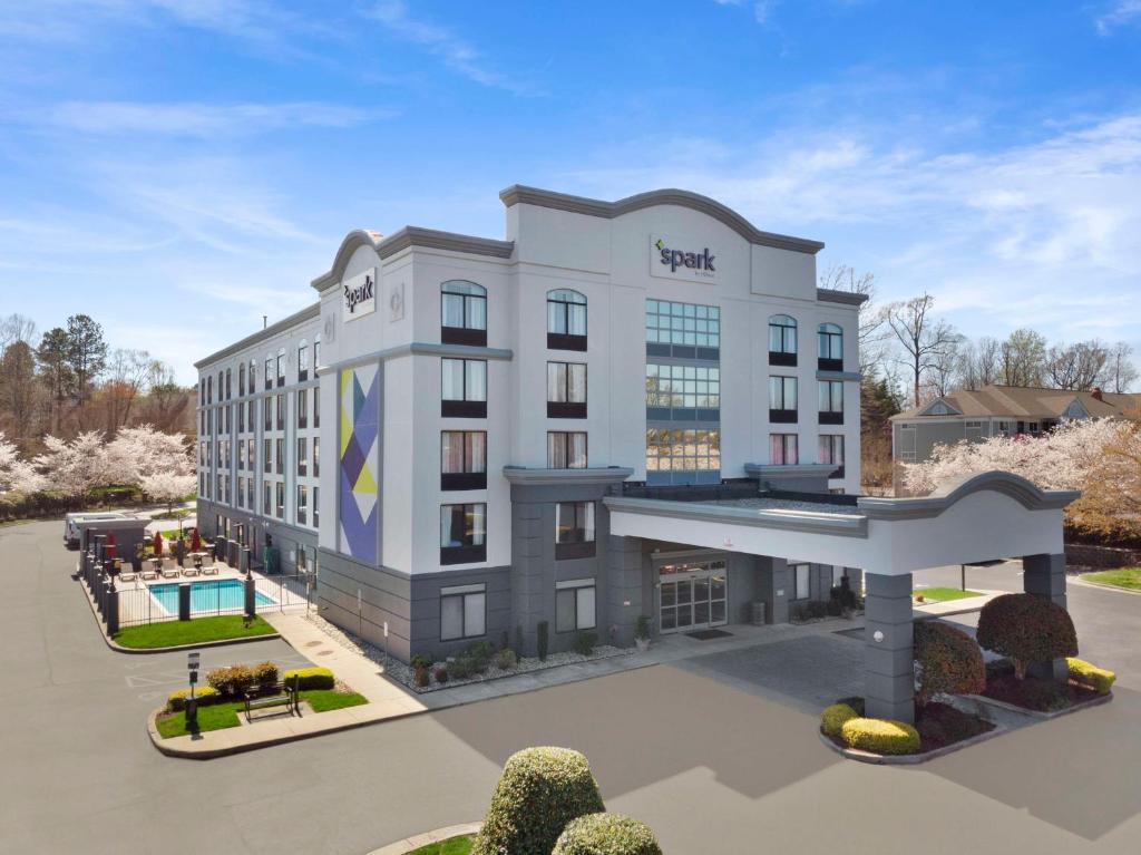 a rendering of a hotel building with a pool at Spark By Hilton Greensboro in Greensboro