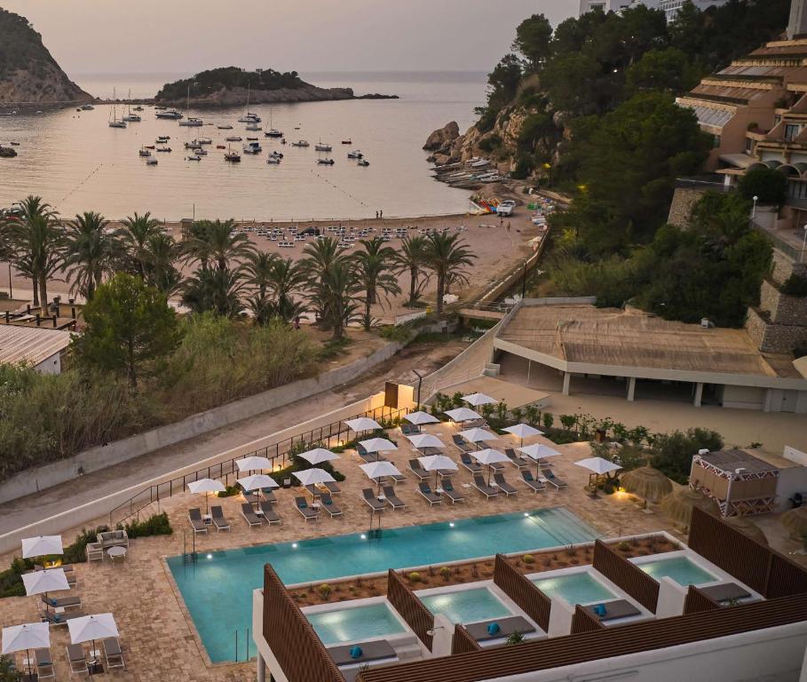 een luchtzicht op een resort met een zwembad en een strand bij The Club Cala San Miguel Hotel Ibiza, Curio Collection by Hilton, Adults only in Puerto de San Miguel