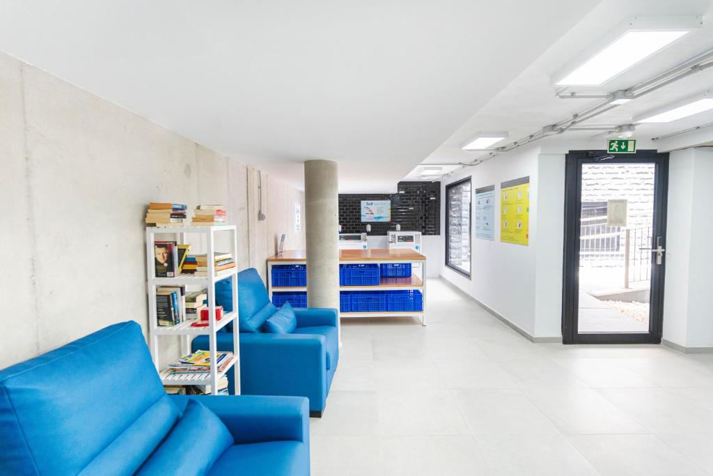 a waiting room with blue couches in a hospital at Esmeralda Cotillo Homes by LIVVO in El Cotillo