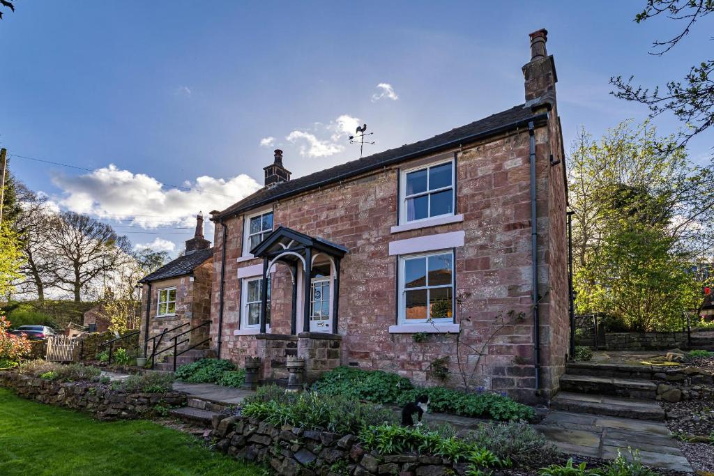 a brick house with a garden in front of it at Finest Retreats - Spring Cottage in Endon