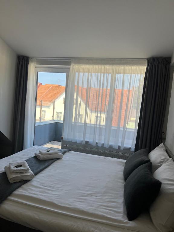 Postel nebo postele na pokoji v ubytování Dangė Hotel