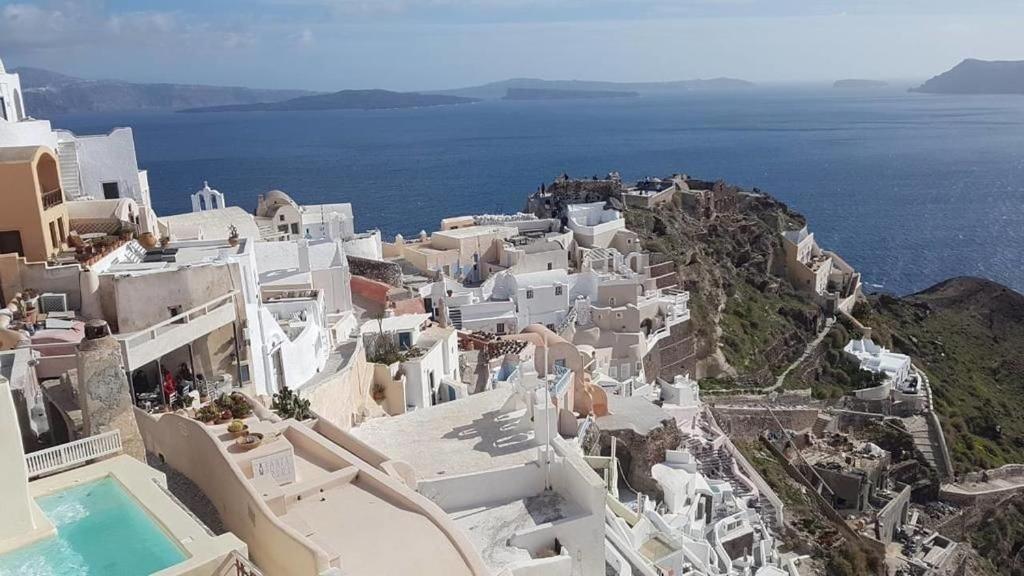 an aerial view of a group of white buildings and the ocean at Beautiful Oia Villa - Spectacular Sea Views - Sunset & Caldera Views - Aegean Serenity Villa in Oia