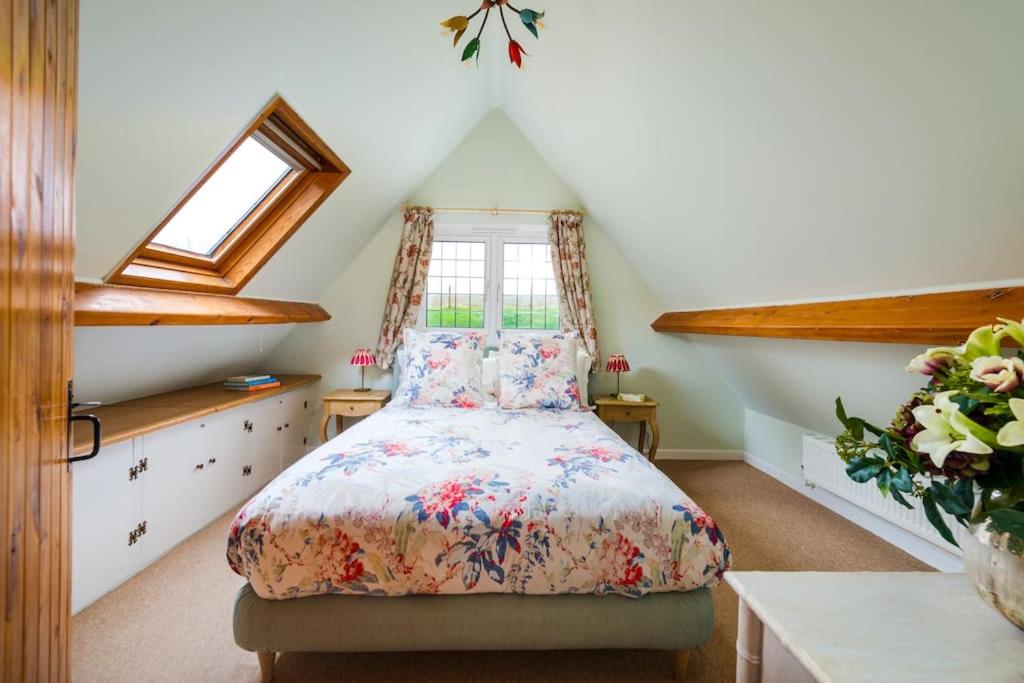 a bedroom with a bed in a attic at NEW Little Till - Riverside Cottage nr Stonehenge in Winterbourne Stoke
