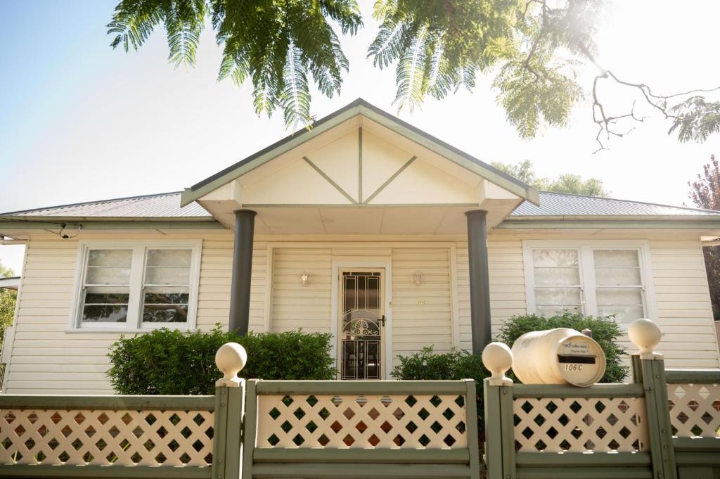 a house with a fence in front of it at Piper Belle in Tamworth