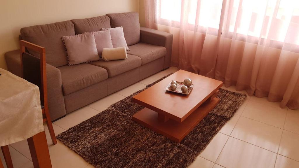 ein Wohnzimmer mit einem Sofa und einem Couchtisch in der Unterkunft Remarkable 3-Bed House in Machico in Machico