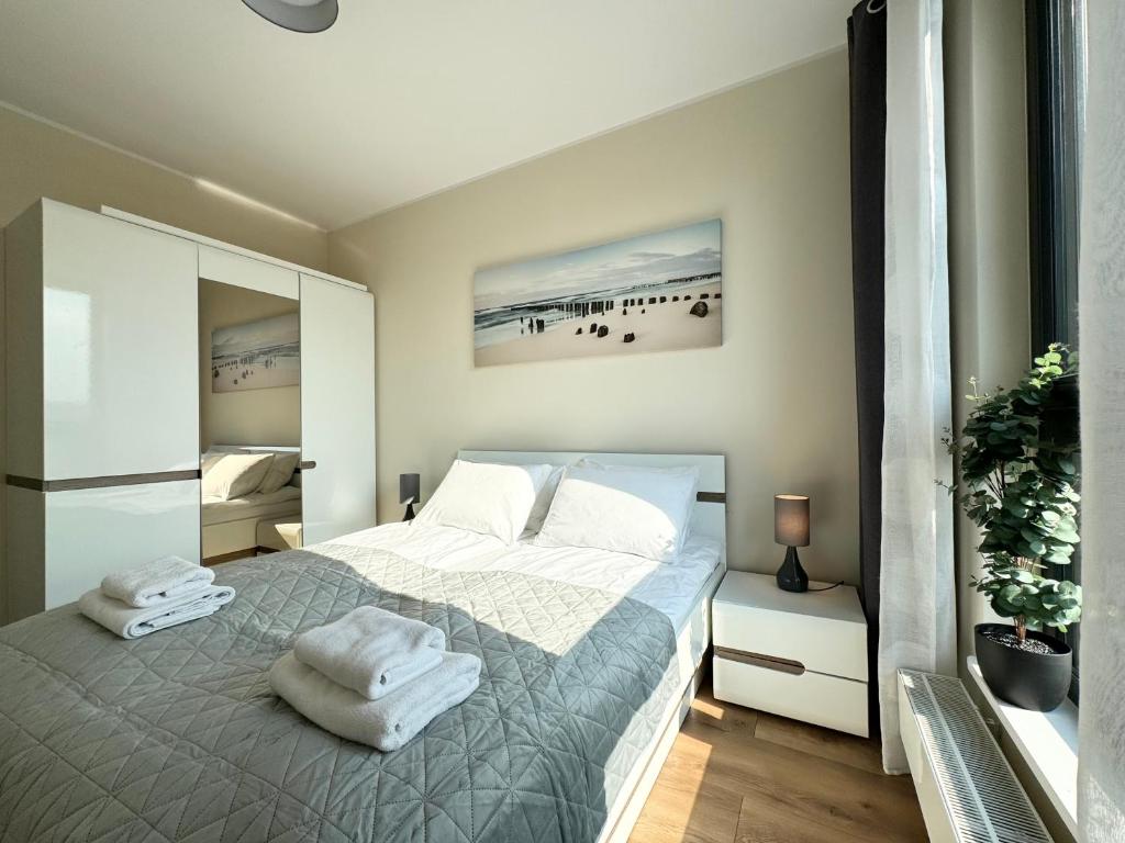 Posteľ alebo postele v izbe v ubytovaní Apartamenty Portova Q4Apartments