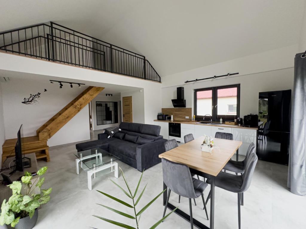 a living room with a couch and a table at Dom nad Selmętem in Mrozy Wielkie