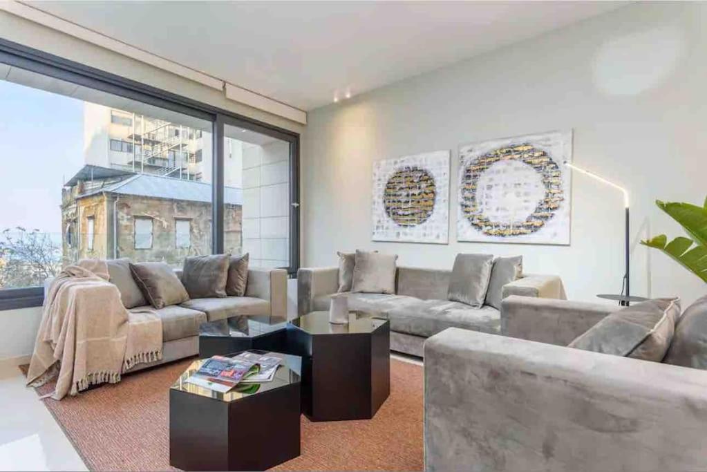 a living room with a couch and a table at Luxurious Saifi 477, 2-BR Apt in Beirut